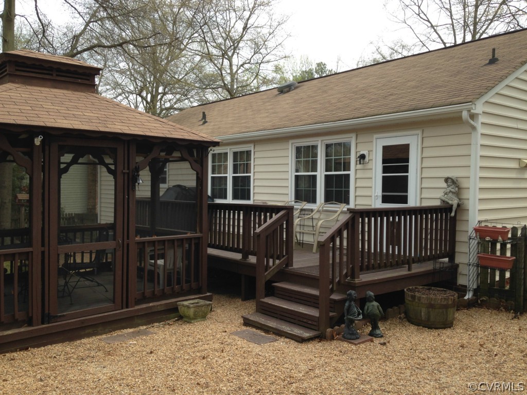 16131 Sandwave Road Chester, VA 23831 - Photo 19 of 24 a view of a house with a wooden deck and furniture