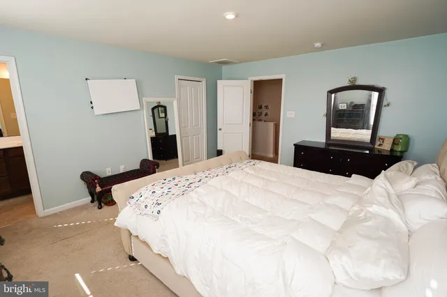 a bathroom with a sink vanity granite and toilet
