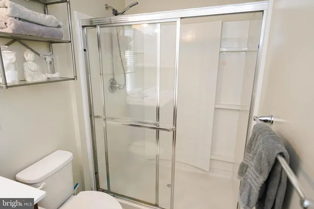 a living room with furniture and a baby crib