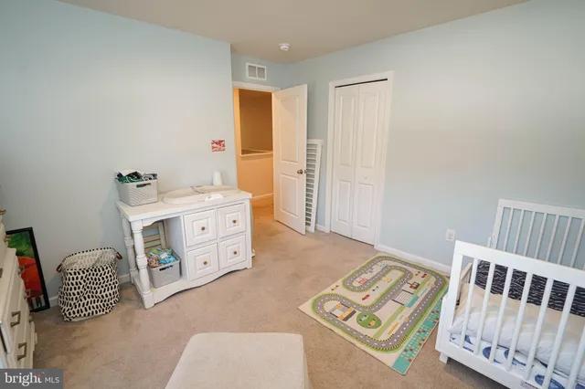 a bedroom with a bed and a desk in it