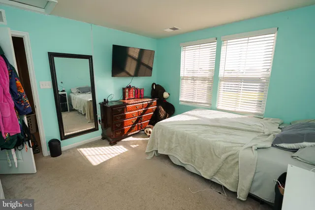 a bedroom with a bed a desk and chair