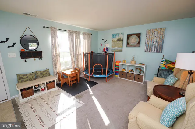 a living room with furniture gym equipment and a window