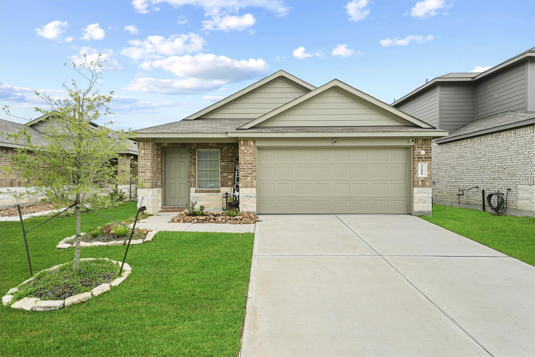 22411 Gilded Peak Lane Spring, TX 77373 - Photo 1 of 16 a view of a white house next to a yard with big trees