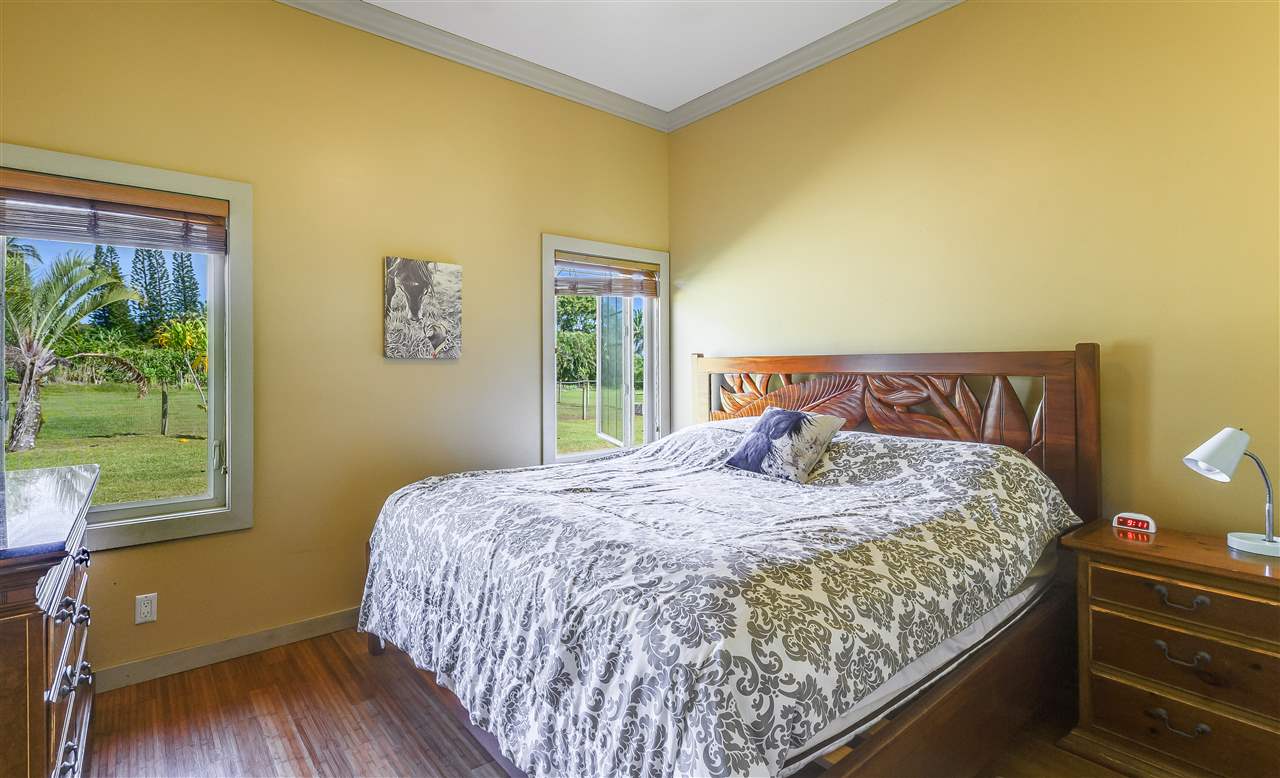 90 Kaupakalua Road Haiku, HI 96708 - Photo 17 of 30 a bedroom with a bed and wooden floor