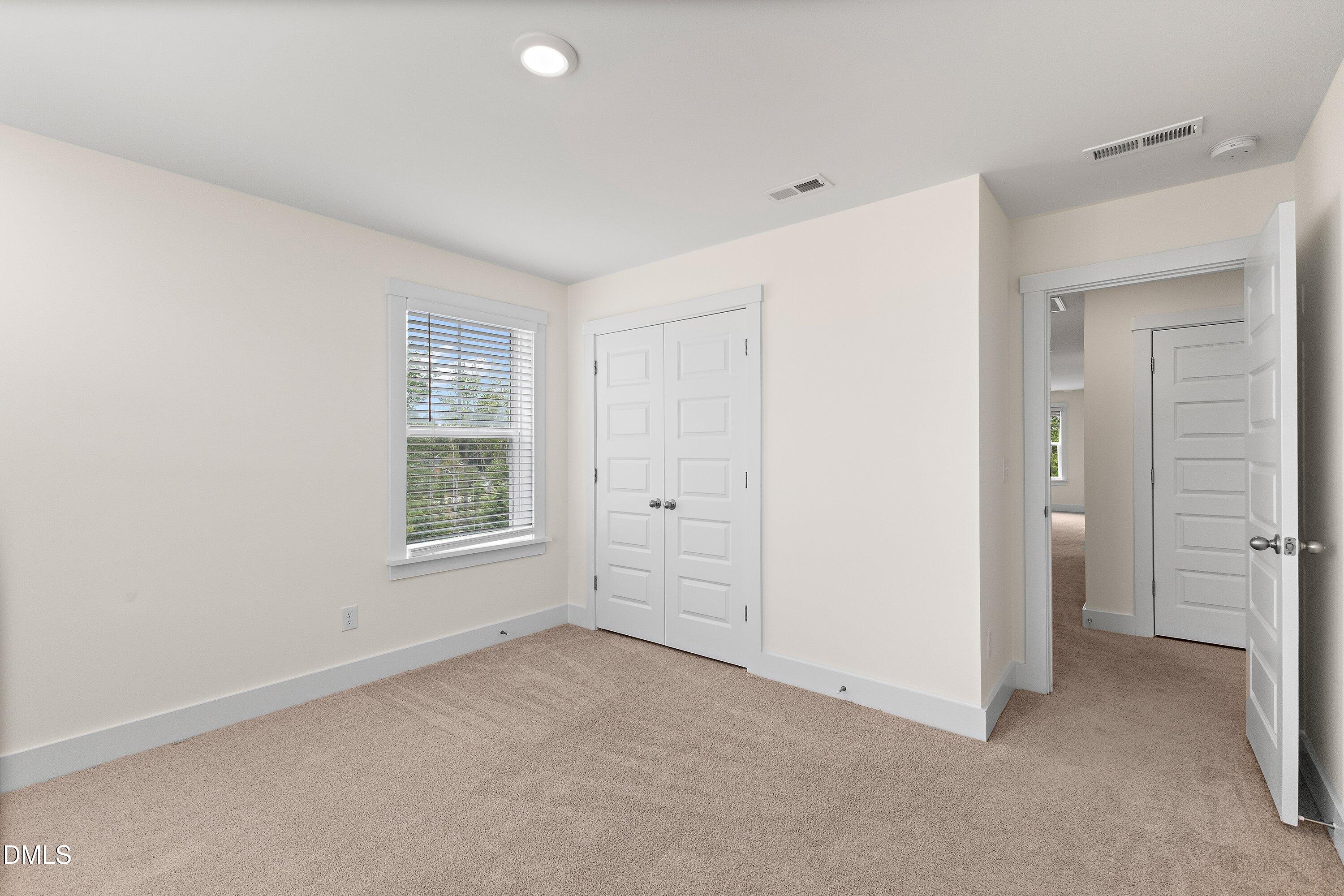 156 Sears Ridge Lane Morrisville, NC 27560 - Photo 31 of 49 an empty room with windows and closet