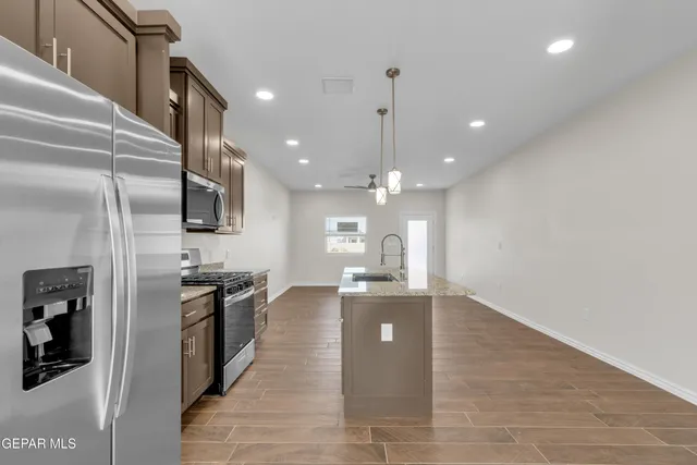 a view of kitchen with sink microwave and stove
