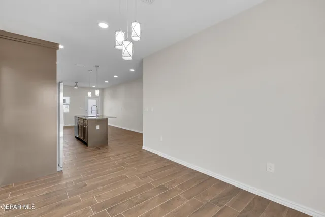 a view of a kitchen with a sink and a chandelier