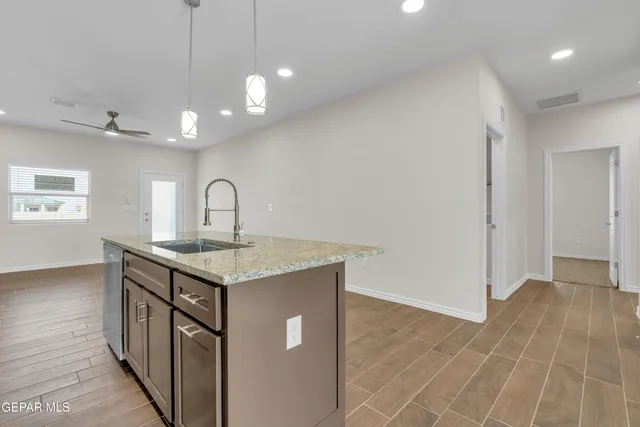 a kitchen with a sink a counter space and a window