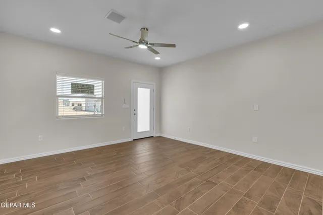 wooden floor in an empty room with a window