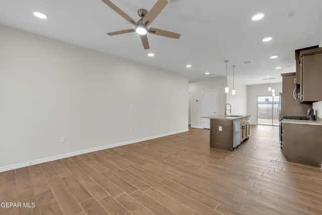 a view of kitchen with microwave and wooden floor