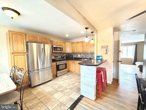 12405 Sweet Briar Road Philadelphia, PA 19154 - Photo 2 of 28 a kitchen with granite countertop stainless steel appliances and wooden cabinets