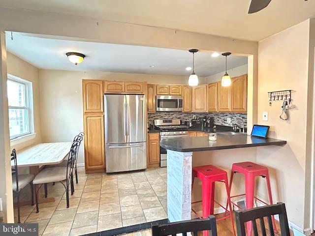 12405 Sweet Briar Road Philadelphia, PA 19154 - Photo 3 of 28 a kitchen with stainless steel appliances kitchen island granite countertop a table chairs in it and wooden floors