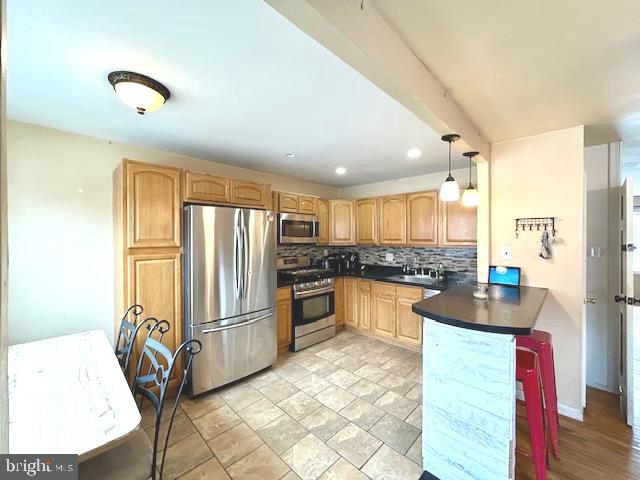 12405 Sweet Briar Road Philadelphia, PA 19154 - Photo 5 of 28 a kitchen with granite countertop a refrigerator stove top oven dining table and chairs