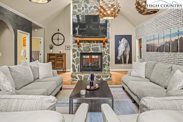 a living room with fireplace furniture and a large window