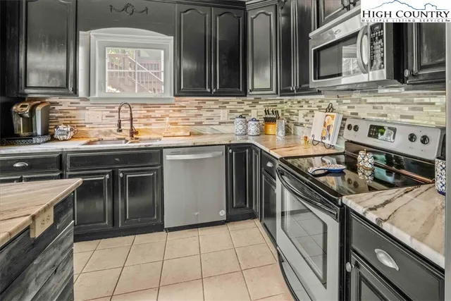 a living room with furniture and floor to ceiling windows