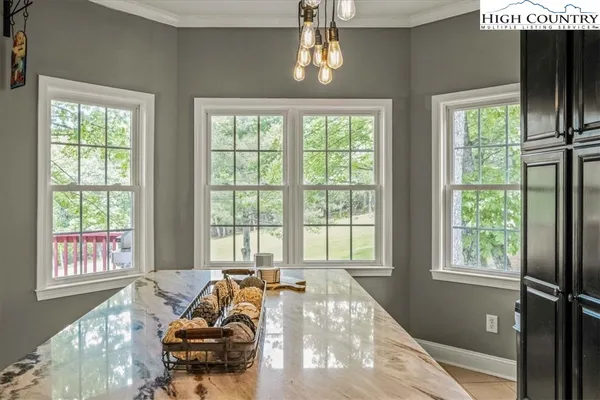 a kitchen with a sink and chairs