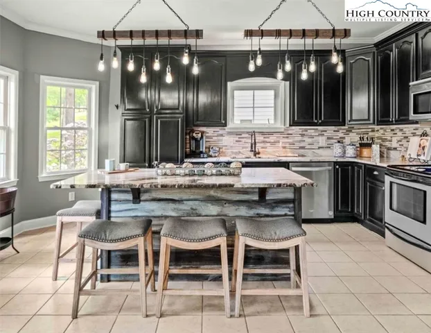 a bedroom with a bed and a potted plant next to a window