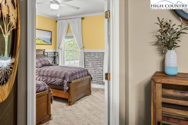 a bedroom with two beds and a chandelier