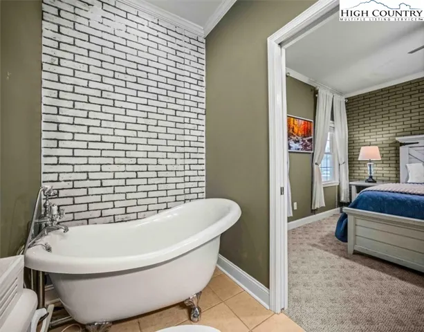 a spacious bedroom with a bed and a flat screen tv