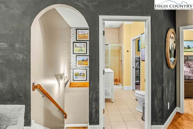 a bathroom with a toilet and a shower curtain