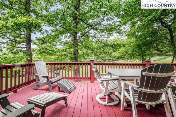 a view of a wooden deck with chairs