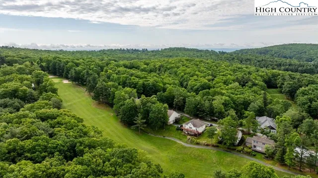 a view of a lake with a house in the background