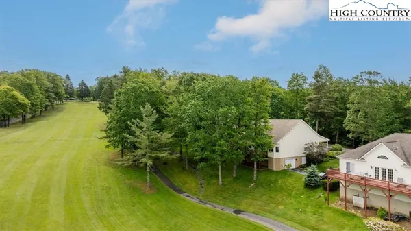 a picture of a park with a bench in front of it