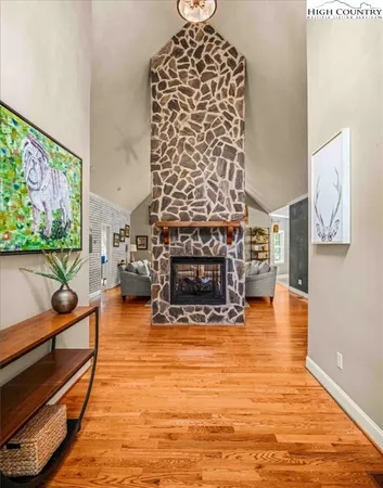 a living room with furniture and a floor to ceiling window