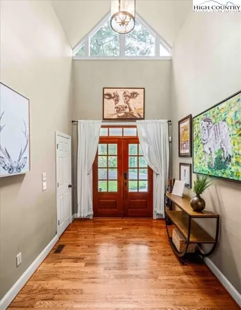 a living room with furniture a fireplace and a large window