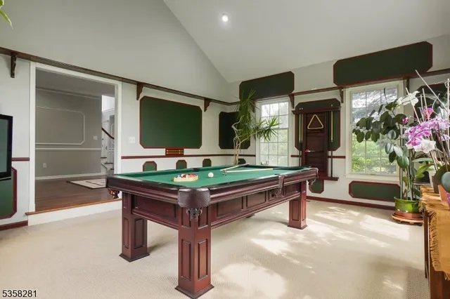 a room with pool table and windows