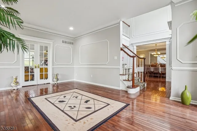 a view of a livingroom with wooden floor and furniture