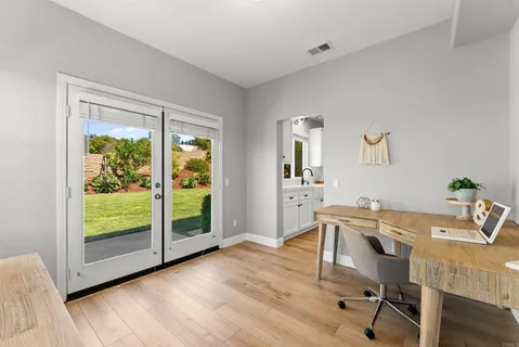 a view of a workspace with furniture and a window