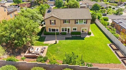 an aerial view of a house with swimming pool garden and patio