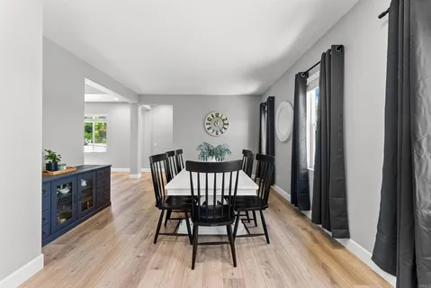 a view of a dining room with furniture window and wooden floor