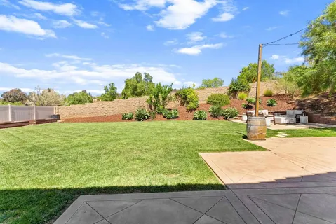 a view of yard with swimming pool and green space