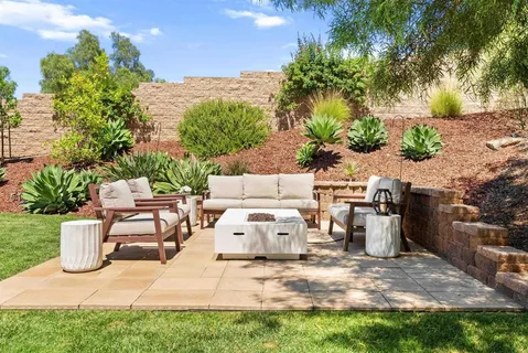 a view of a backyard with sitting area