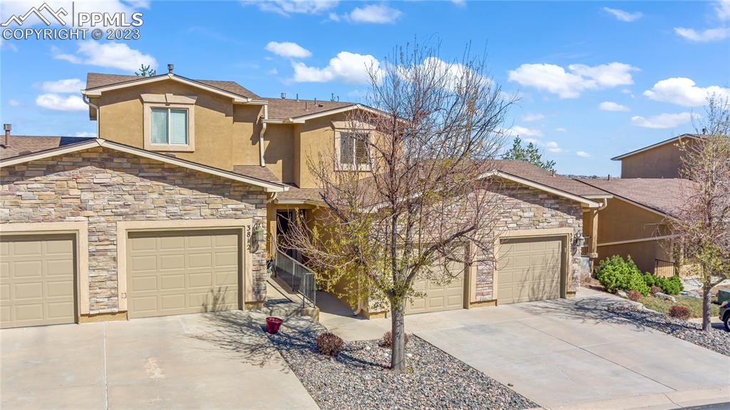 3822 Homestead Ridge Heights Colorado Springs, CO 80917 - Photo 17 of 17 a front view of a house with a yard and garage