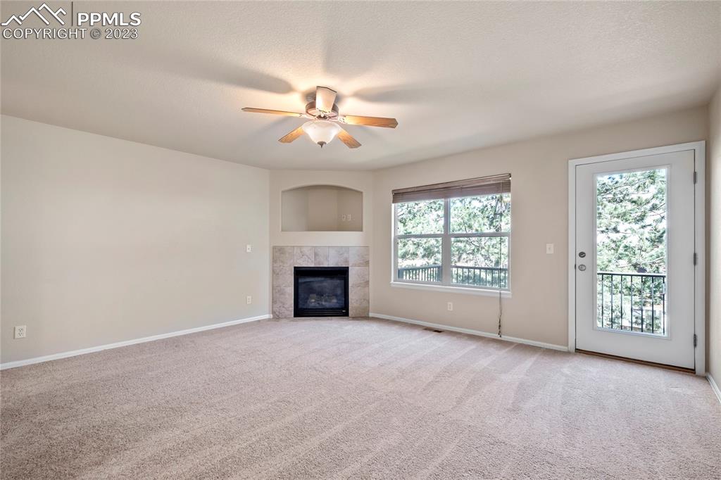 3822 Homestead Ridge Heights Colorado Springs, CO 80917 - Photo 3 of 17 wooden floor in an empty room with a fireplace