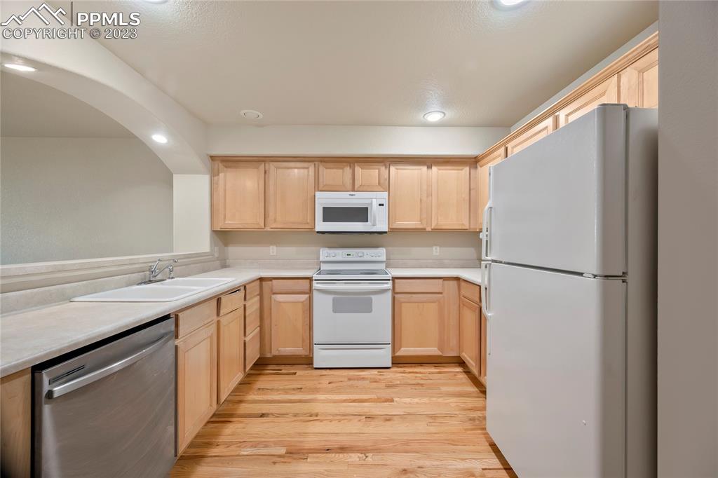 3822 Homestead Ridge Heights Colorado Springs, CO 80917 - Photo 5 of 17 a kitchen with granite countertop stainless steel appliances a refrigerator cabinets and a sink