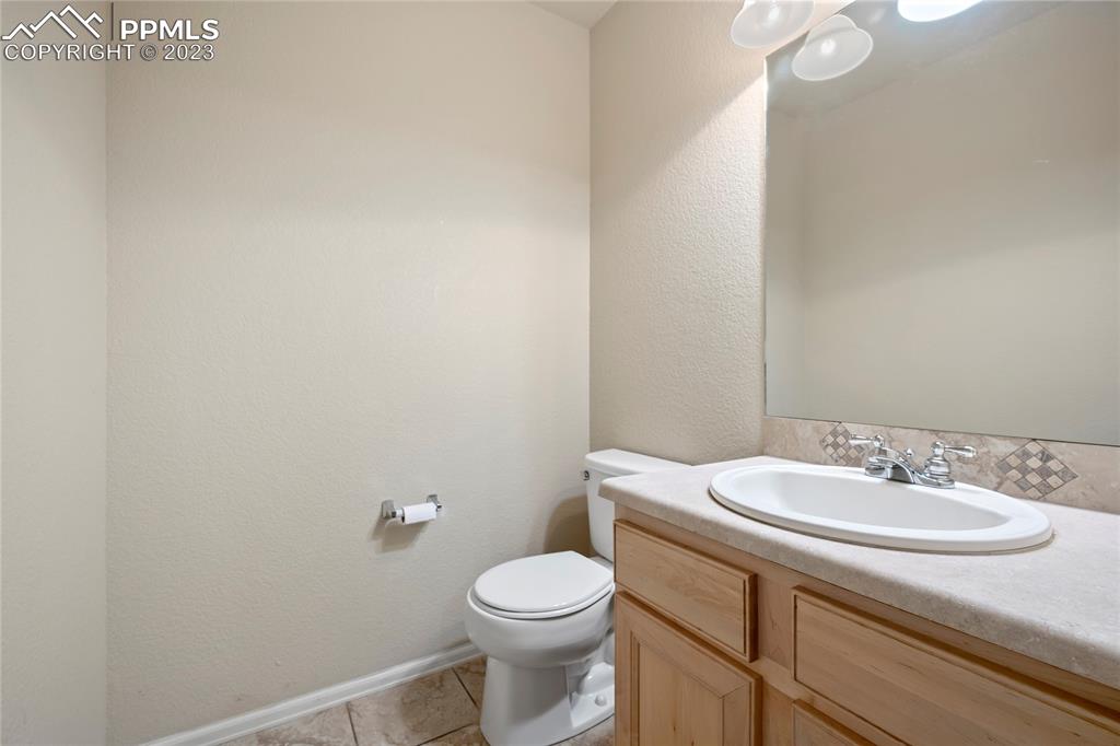 3822 Homestead Ridge Heights Colorado Springs, CO 80917 - Photo 7 of 17 a bathroom with a sink a toilet and mirror