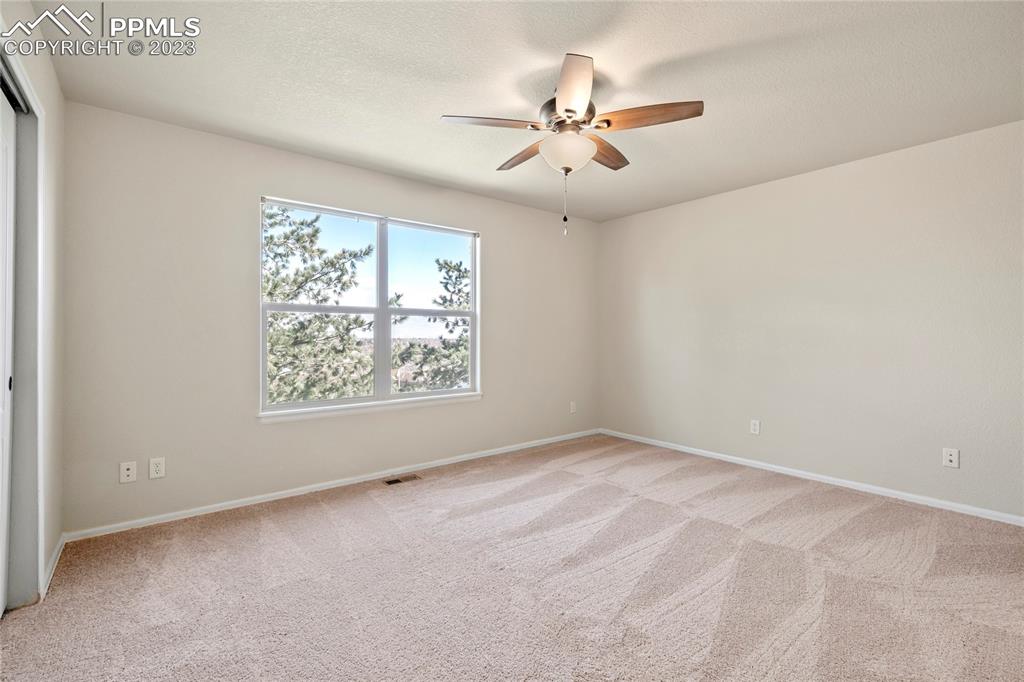 3822 Homestead Ridge Heights Colorado Springs, CO 80917 - Photo 8 of 17 an empty room with windows and fan