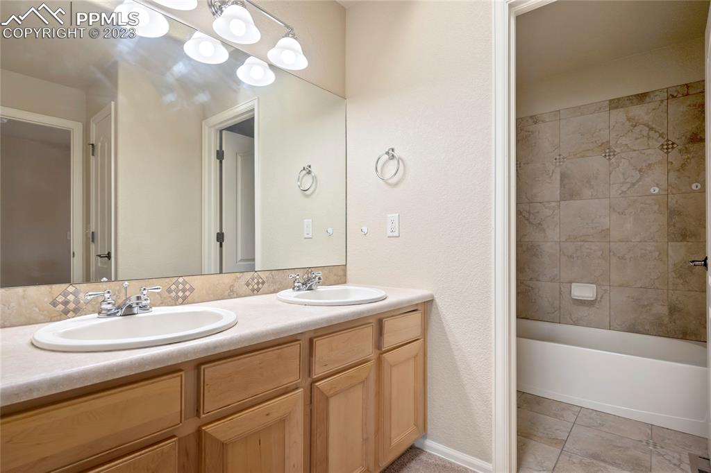 3822 Homestead Ridge Heights Colorado Springs, CO 80917 - Photo 10 of 17 a bathroom with a sink a mirror and a bathtub