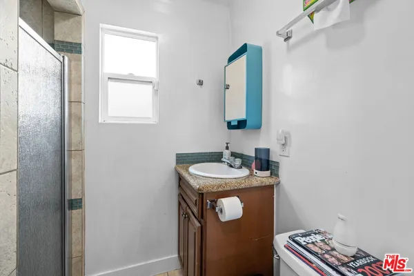 a bathroom with a sink a mirror and vanity