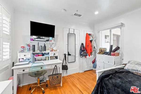 a bedroom with furniture and a flat screen tv
