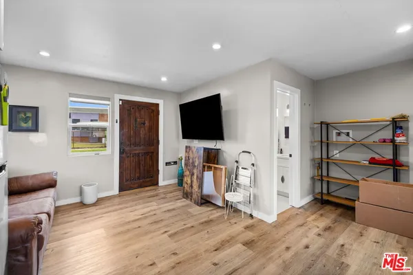a view of a livingroom with furniture and a flat screen tv