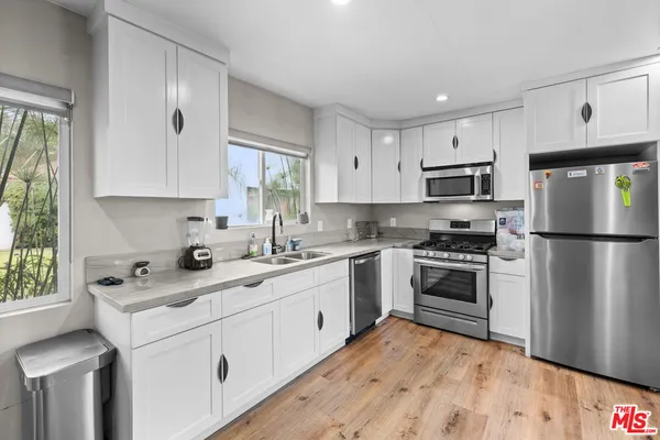 a kitchen with a sink stove and refrigerator