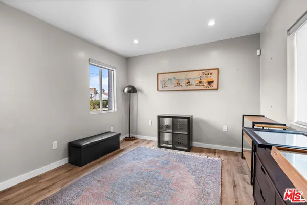 a spacious bedroom with a bed and a desk