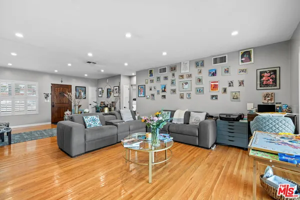 a living room with furniture window and wooden floor