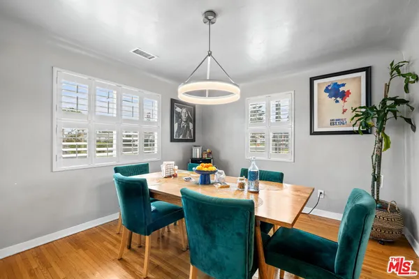 a dining room with furniture a chandelier and window