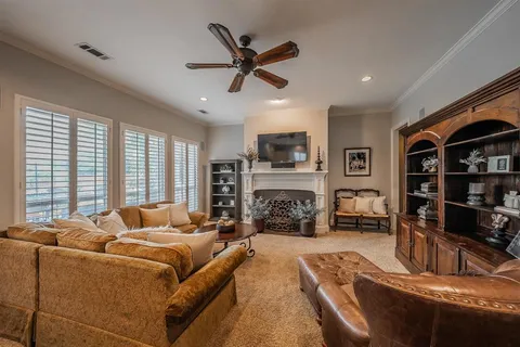 a living room with fireplace furniture and a flat screen tv